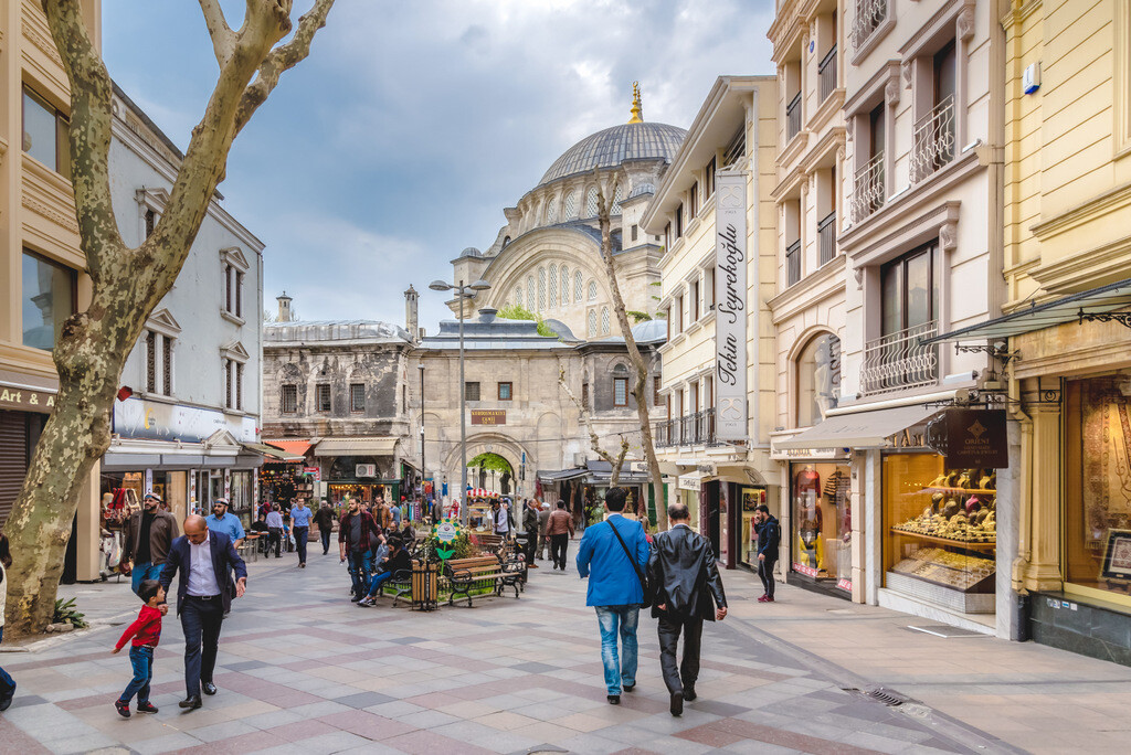 Luxury shops on Nuruosmaniye Street with the iconic Gate 1 of the Grand Bazaar and Nuruosmaniye Mosque in the background