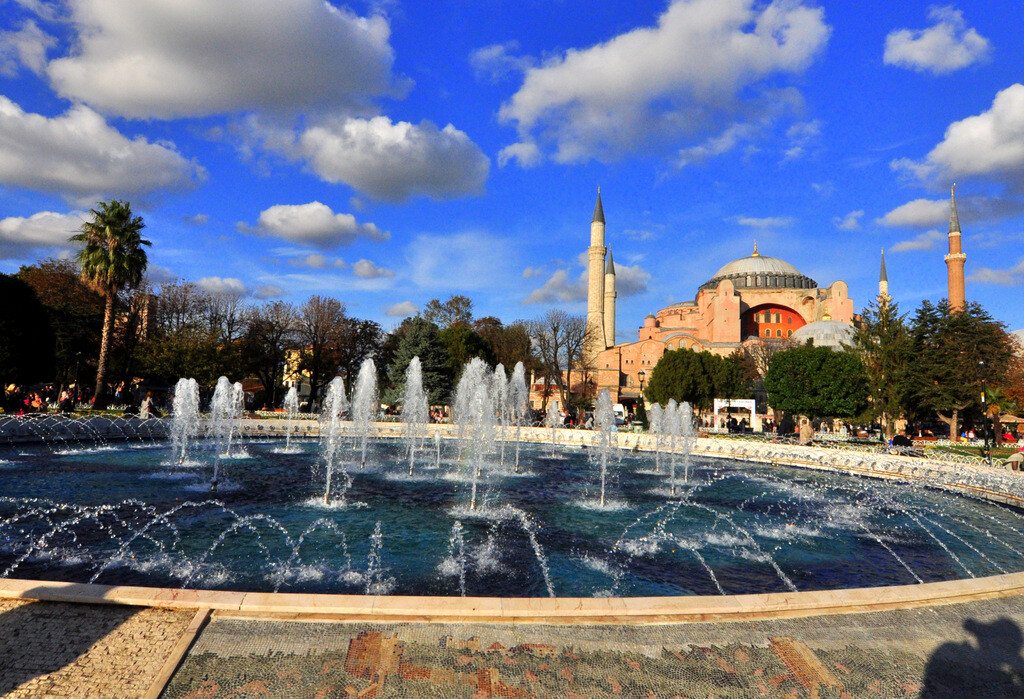 Aerial panoramic view of Hagia Sophia from Sultanahmet Park, showcasing its massive dome and minarets. photo by Serhat Engul