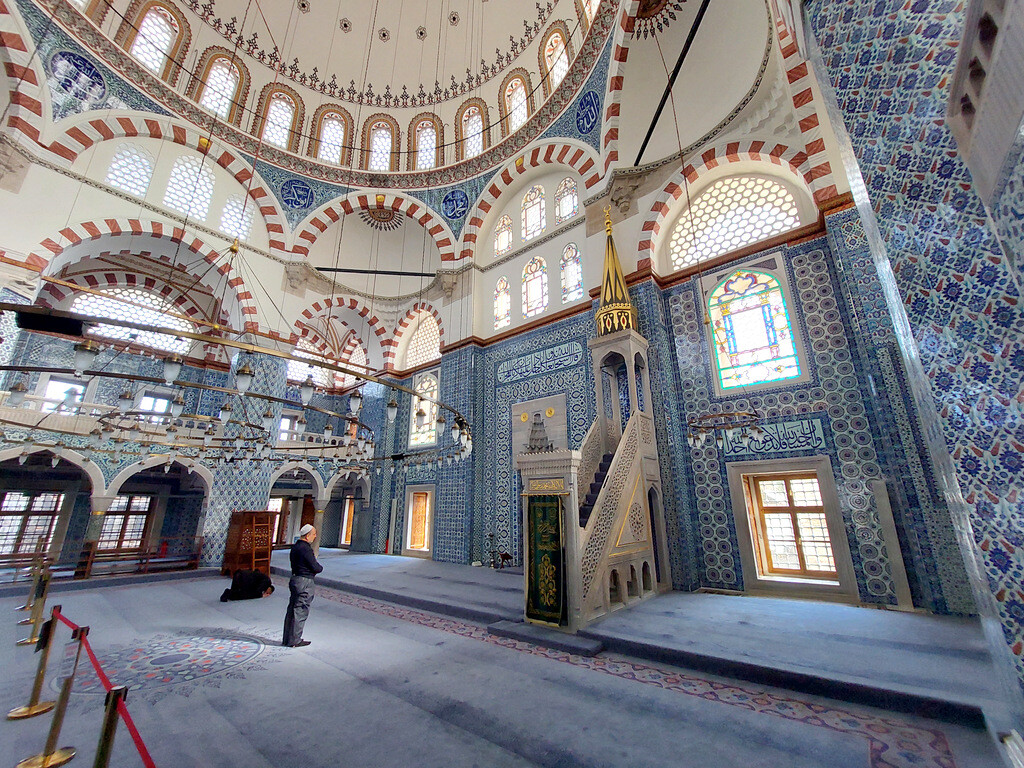 Interior of Rüstem Pasha Mosque near the Spice Bazaar, showing its famous 16th-century Iznik tiles while a local worshipper prays on the light blue carpet. For generations, this historic mosque has served shopkeepers working around Uzunçarşı and the surrounding market streets. photo by Serhat Engul