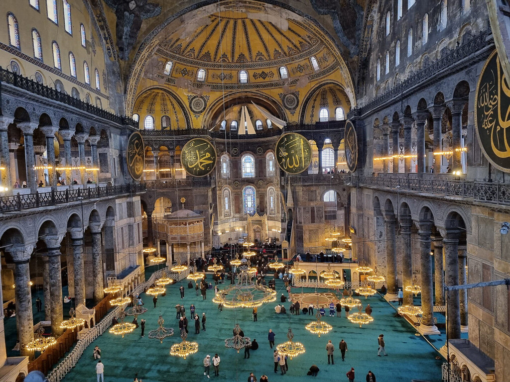 Interior of Hagia Sophia seen from the upper floor, with its grand dome and Islamic calligraphy medallions. photo by Serhat Engul