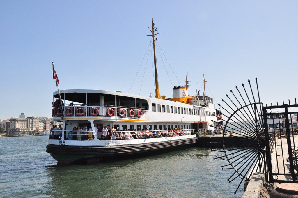 Passengers aboard a Şehir Hatları Bosphorus cruise ferry relaxing on the side deck benches after departing from Eminönü, enjoying the sea breeze and panoramic views of Istanbul during the journey along the Bosphorus Strait, photo by Serhat Engul